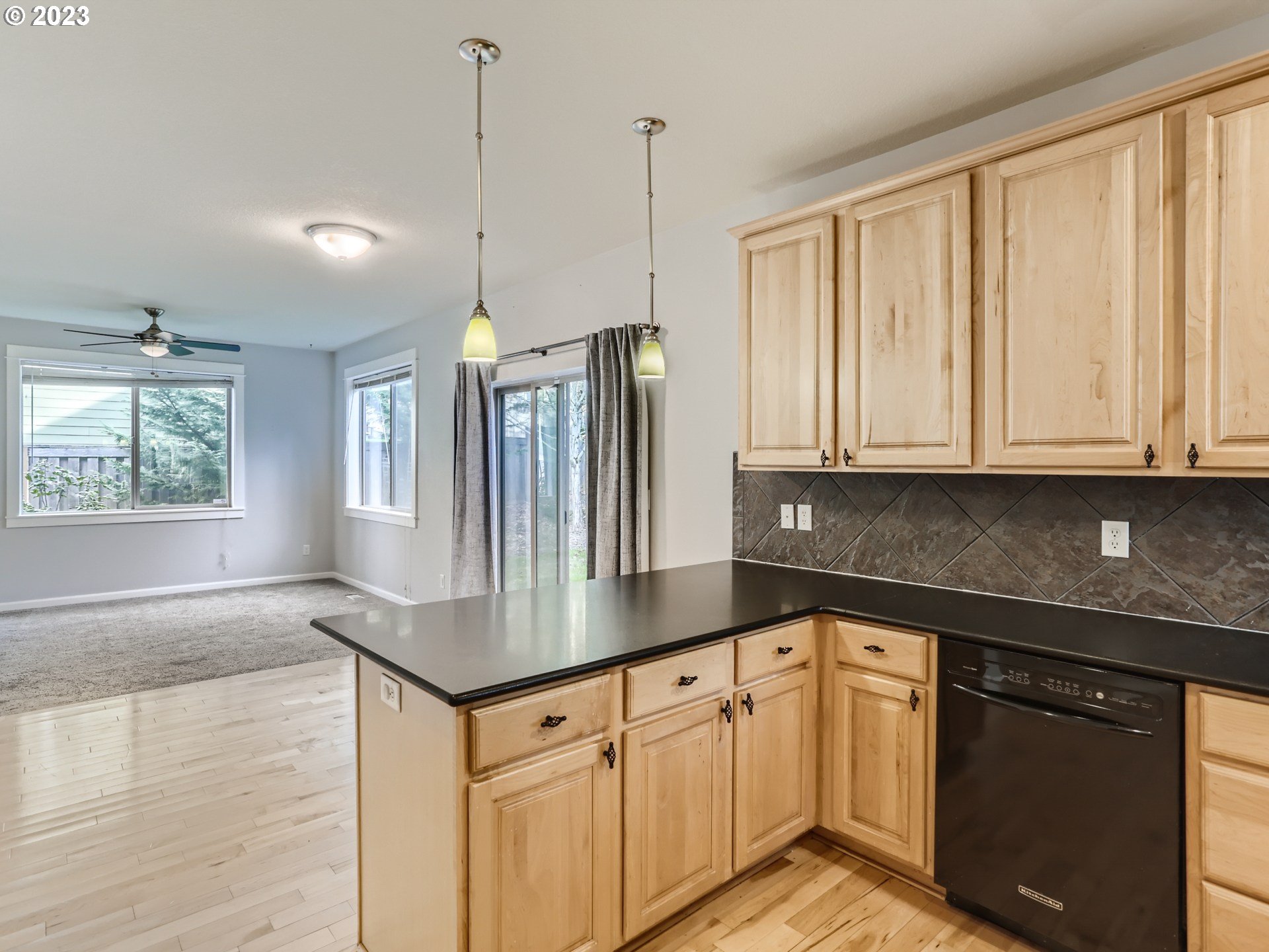 14505 Southeast Clatsop Street Portland, OR 97236 - Photo 11 of 27 a kitchen with granite countertop white cabinets and white appliances