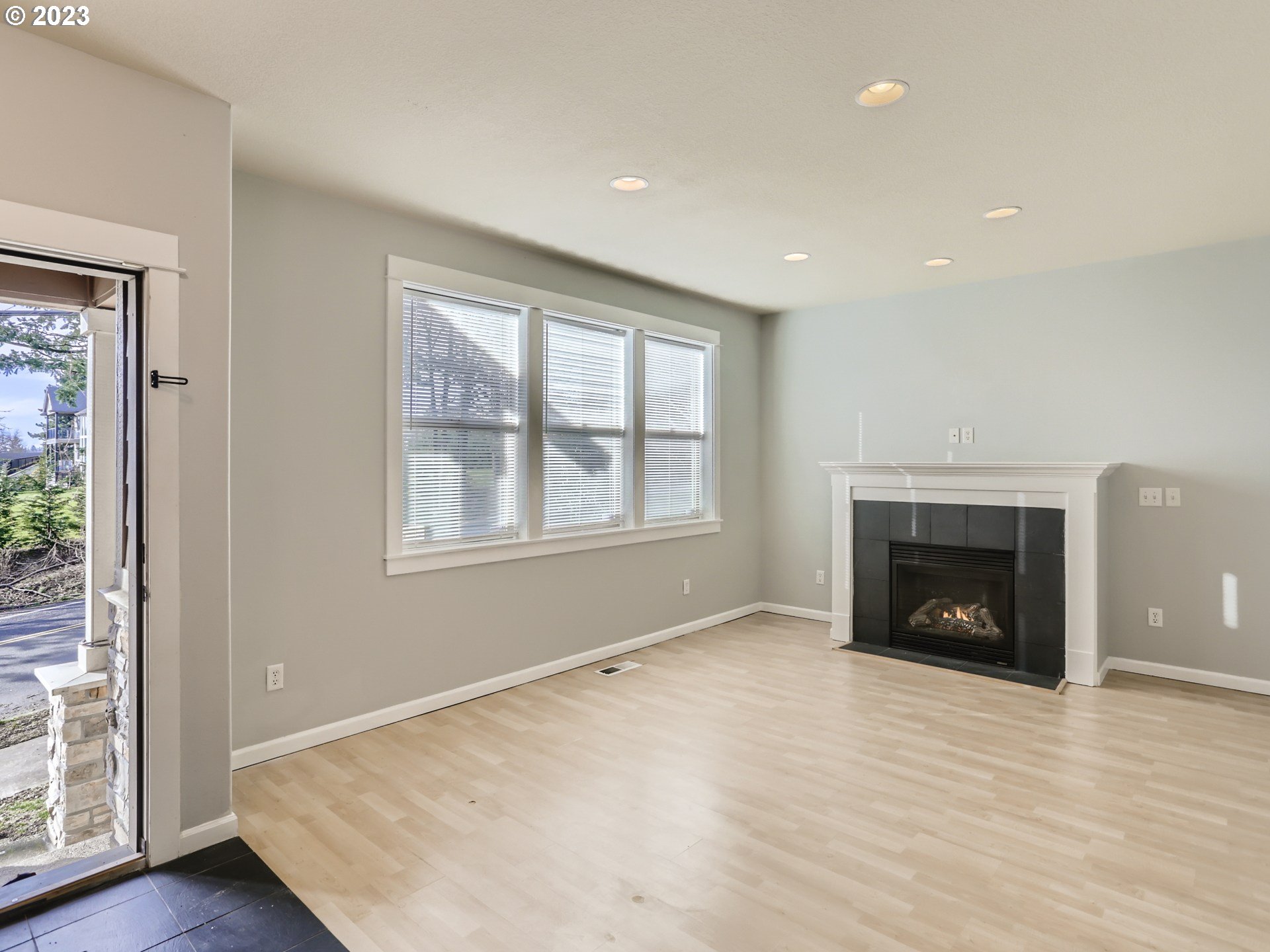 14505 Southeast Clatsop Street Portland, OR 97236 - Photo 12 of 27 an empty room with windows and fireplace