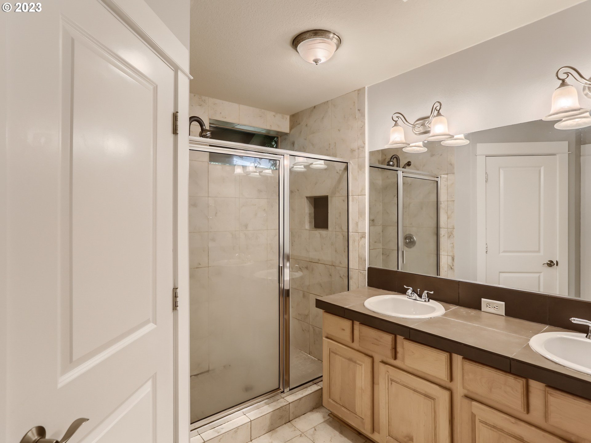 14505 Southeast Clatsop Street Portland, OR 97236 - Photo 16 of 27 a bathroom with a double vanity sink mirror and shower