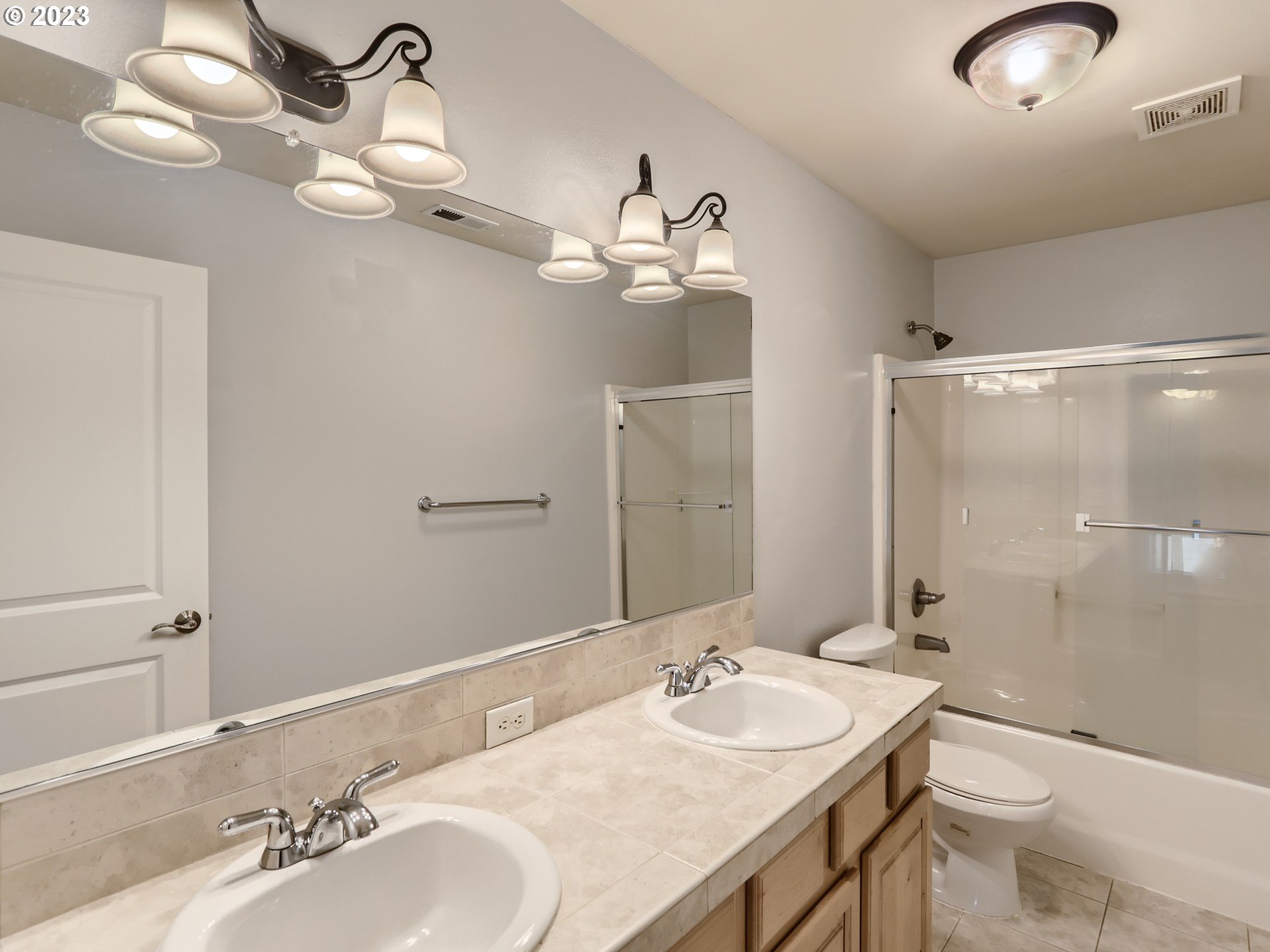 14505 Southeast Clatsop Street Portland, OR 97236 - Photo 20 of 27 a bathroom with a granite countertop sink a toilet and a mirror