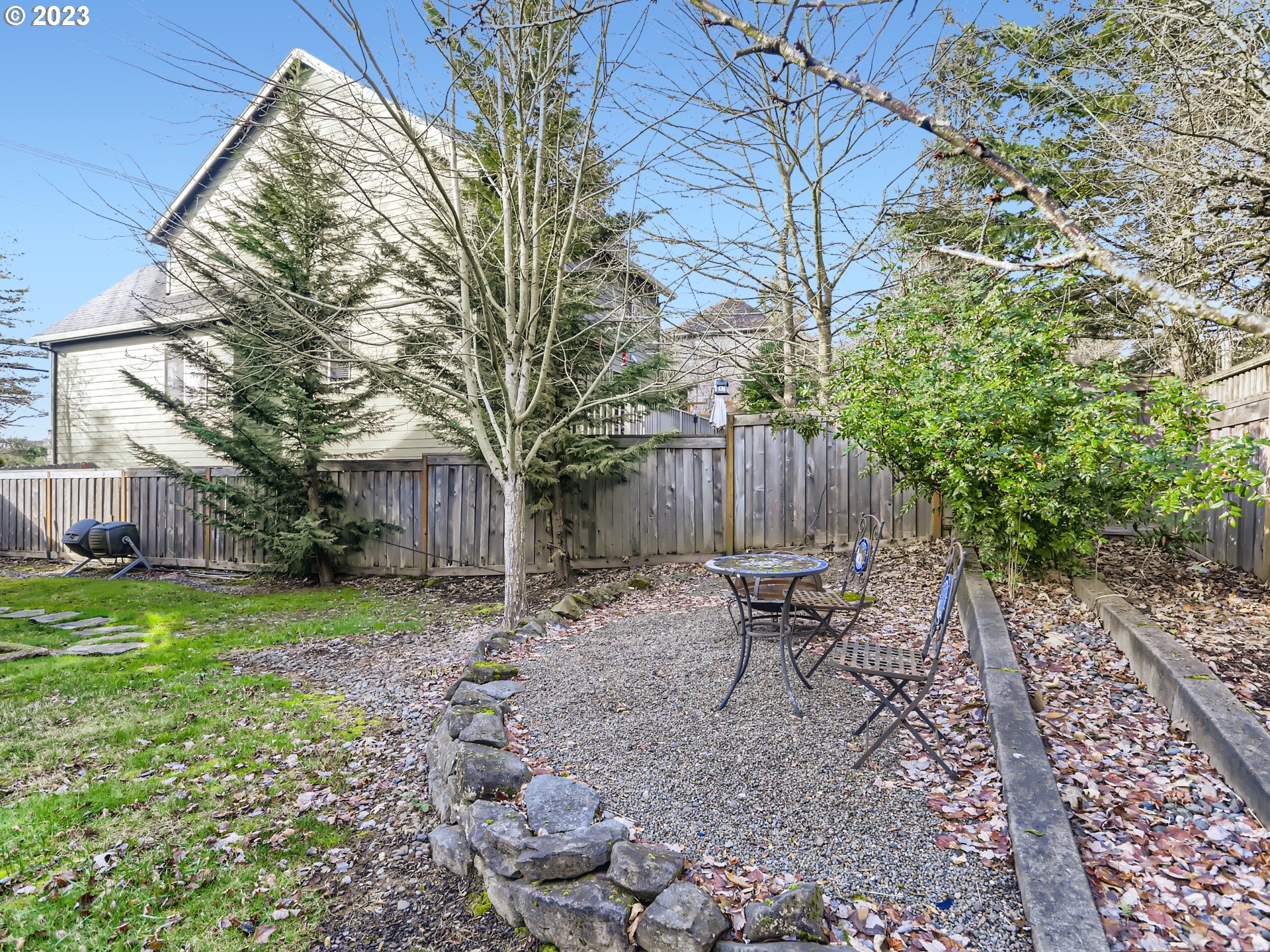 14505 Southeast Clatsop Street Portland, OR 97236 - Photo 26 of 27 a backyard of a house with table and chairs