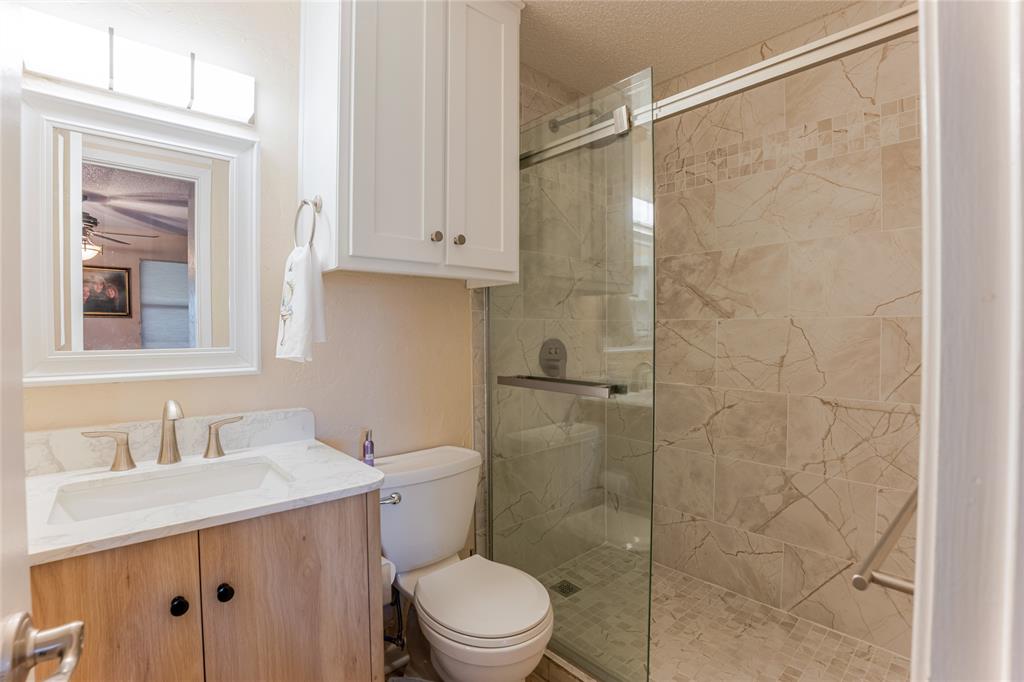 3037 Hells Gate Loop, Unit C208 Strawn, TX 76475 - Photo 18 of 24 a bathroom with a sink a toilet and shower