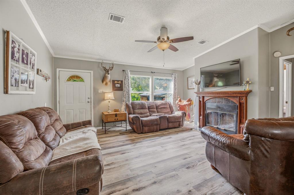 151 High Point Road Weatherford, TX 76088 - Photo 8 of 40 a living room with furniture and a fireplace