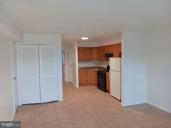 a view of kitchen with refrigerator and microwave