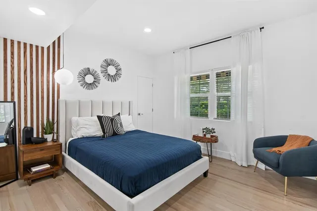 a bedroom with a bed and dresser