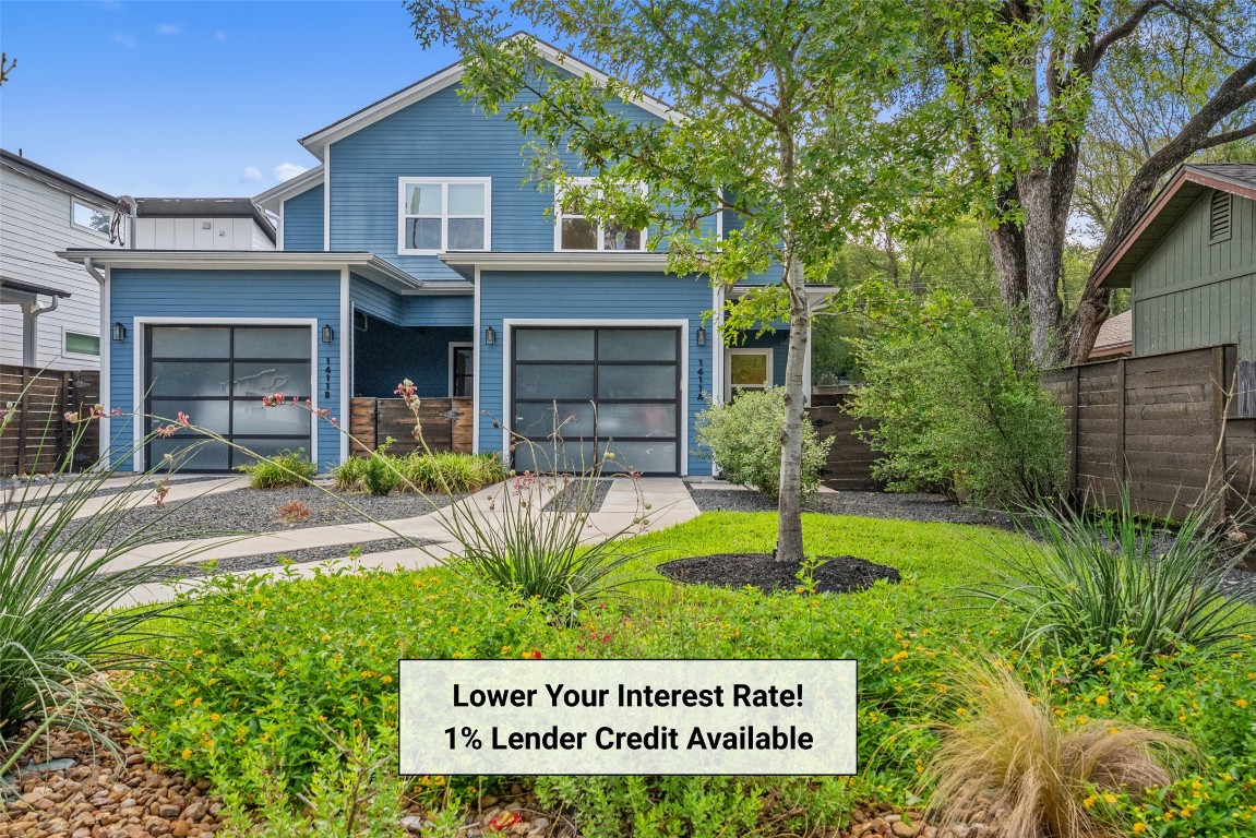 a view of a house with a yard and plants