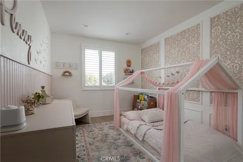 a bedroom with a bed a couch and a window