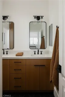 a bathroom with a double vanity sink and a mirror