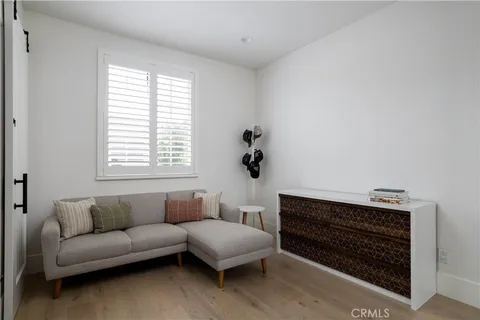 a living room with furniture a window and a lamp