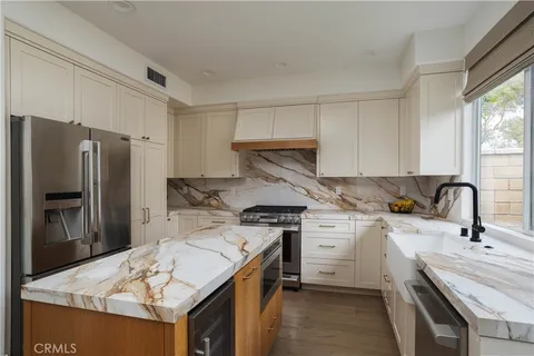 a kitchen with a sink stove and refrigerator