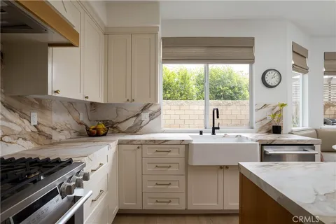 a kitchen with a sink stove top oven and cabinets