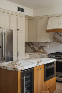 a kitchen with stainless steel appliances granite countertop a stove and a refrigerator