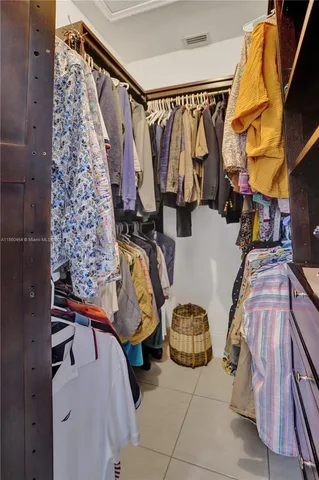 a kitchen with stainless steel appliances granite countertop wooden cabinets a sink dishwasher and a stove top oven