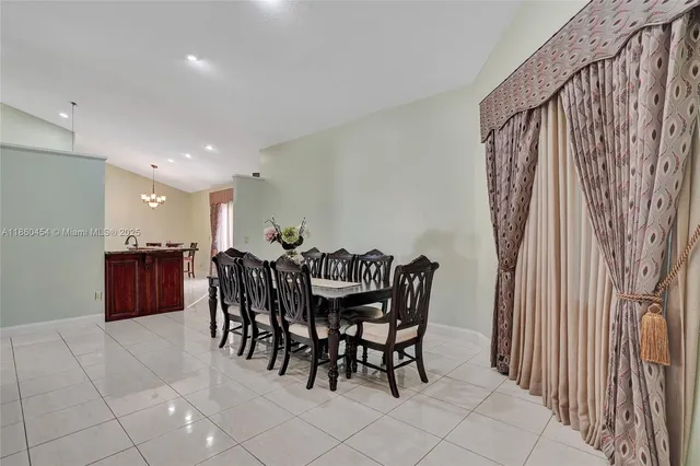 a kitchen with stainless steel appliances granite countertop a stove a sink a refrigerator and a microwave