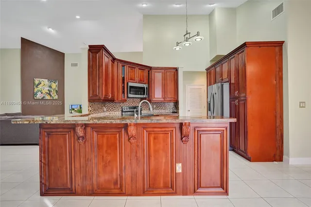a view of a lake with a yard and large trees