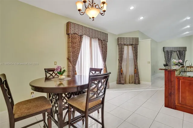a view of a house with a big yard and large trees