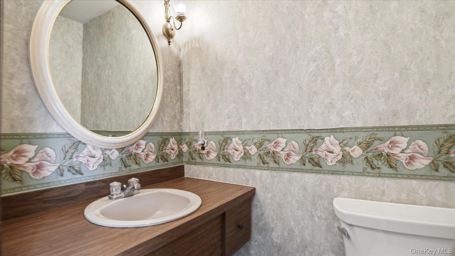641 158th Street Queens, NY 11357 - Photo 13 of 37 a bathroom with a sink mirror vanity and toilet
