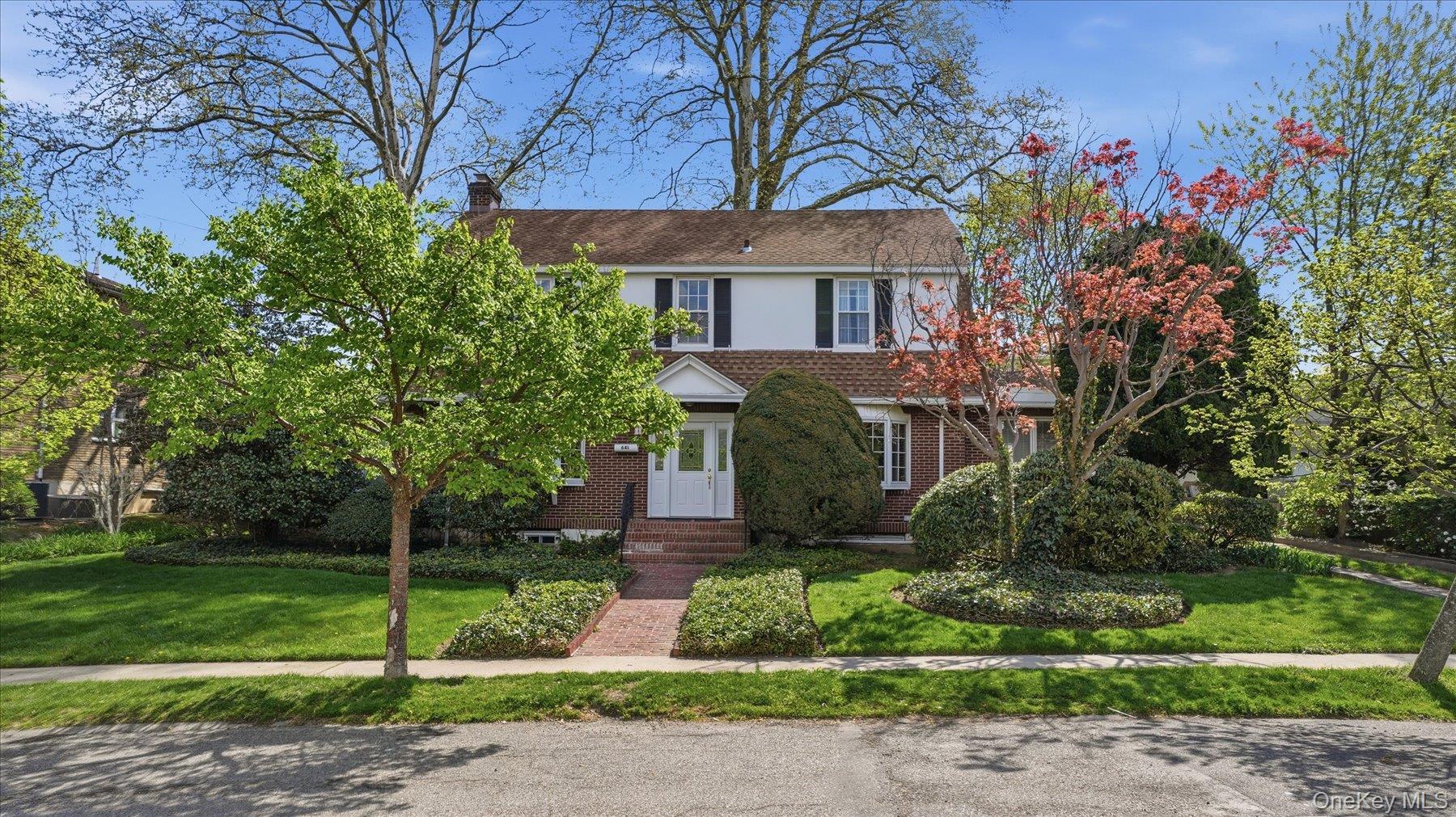 641 158th Street Queens, NY 11357 - Photo 3 of 37 a front view of a house with a garden