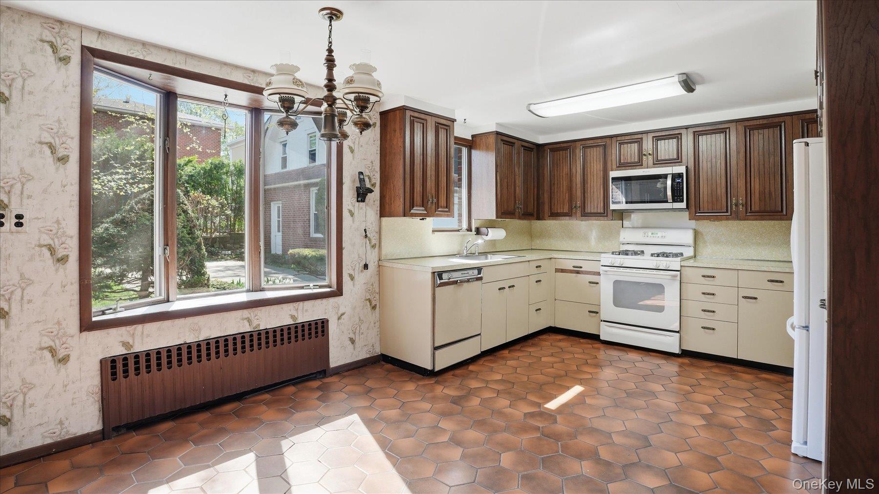 641 158th Street Queens, NY 11357 - Photo 4 of 37 a kitchen that has a lot of cabinets in it and appliances