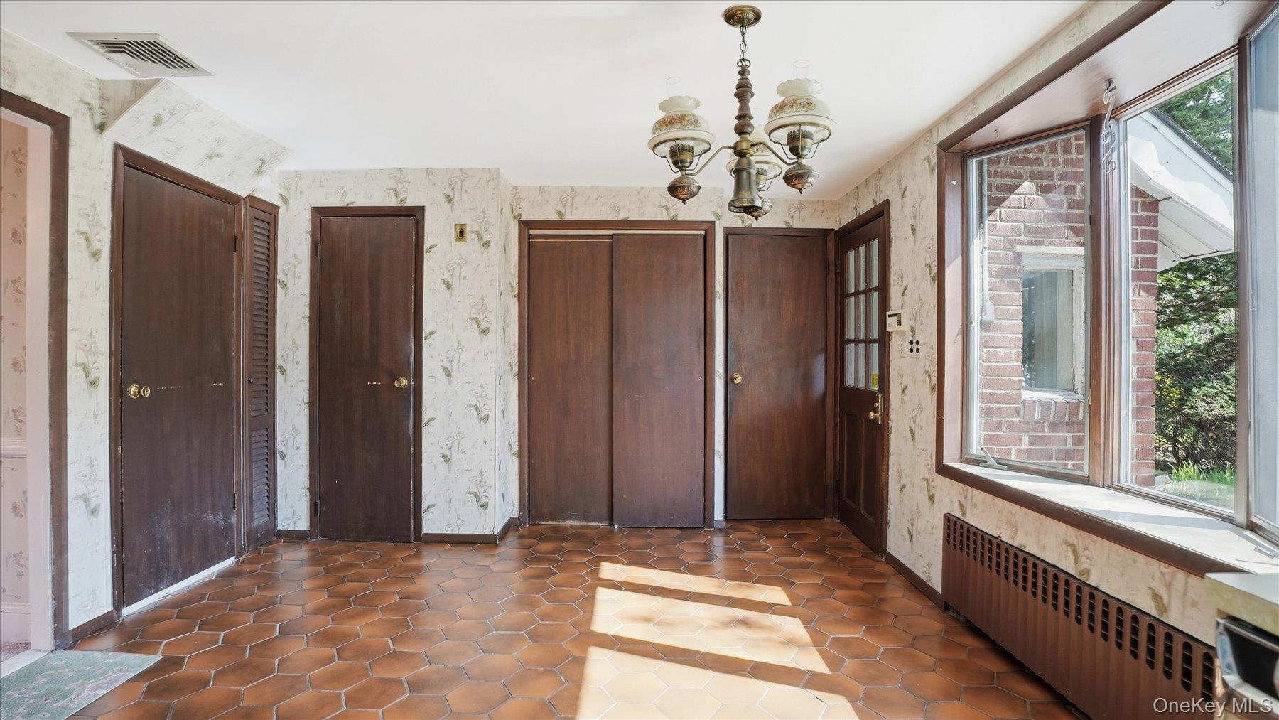 641 158th Street Queens, NY 11357 - Photo 5 of 37 a view of a hallway with windows and chandelier