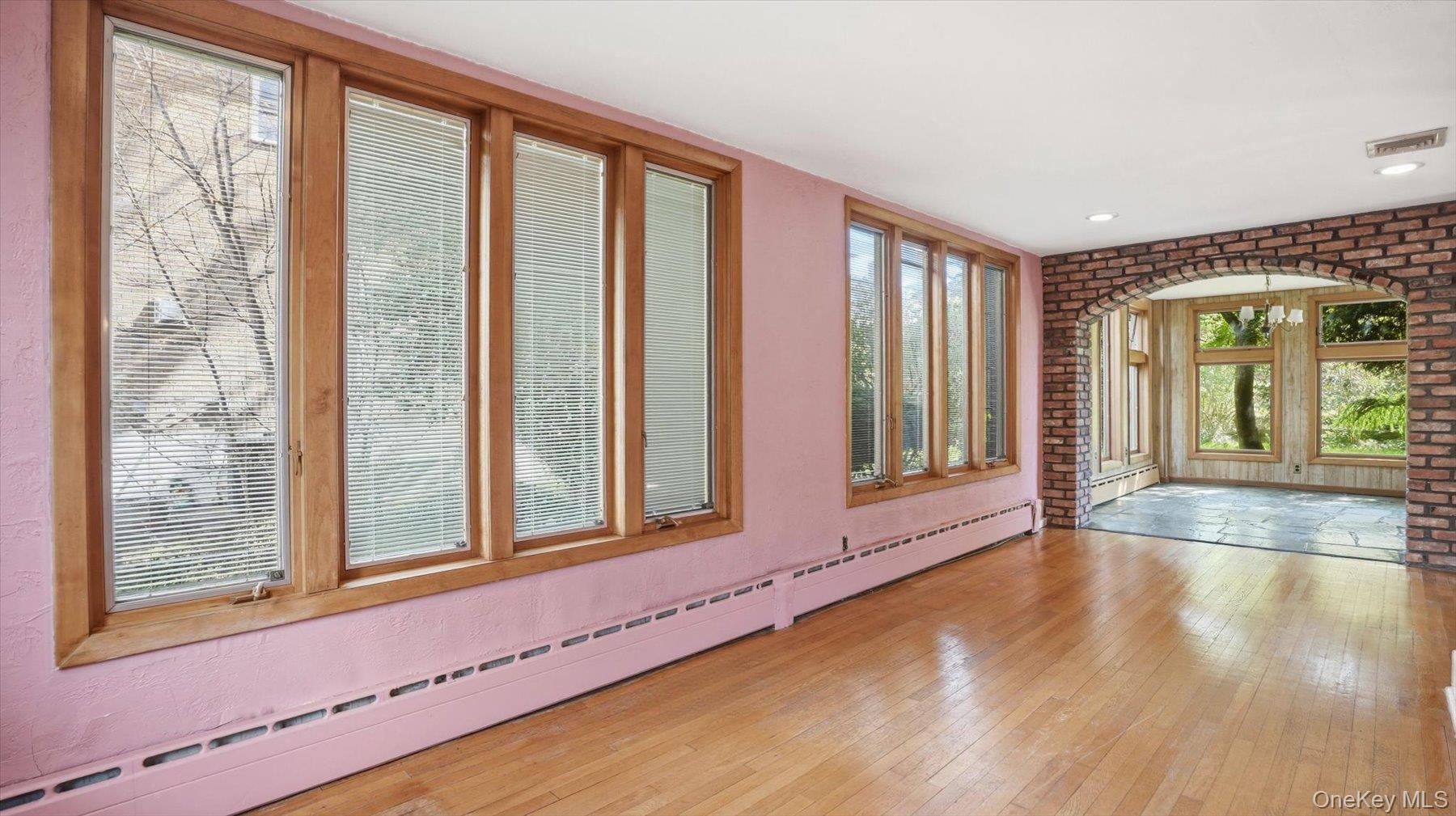 641 158th Street Queens, NY 11357 - Photo 8 of 37 a view of an empty room with wooden floor and a window