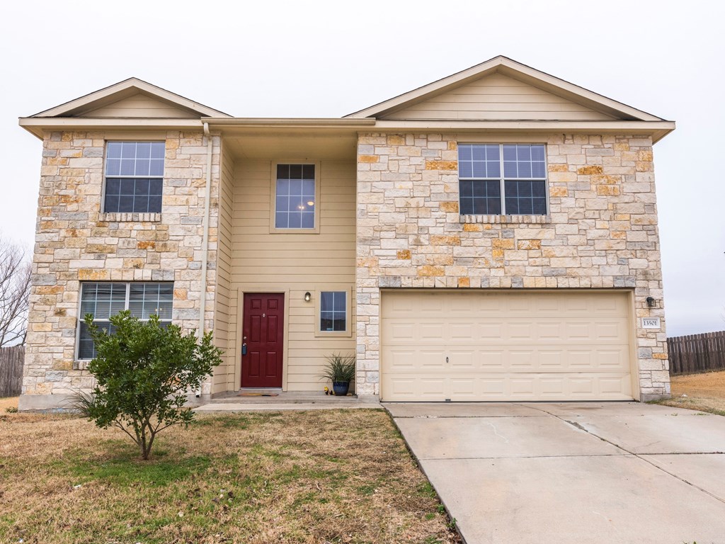 13501 Sierra Wind Lane Elgin, TX 78621 - Photo 1 of 1 a front view of a house with a yard