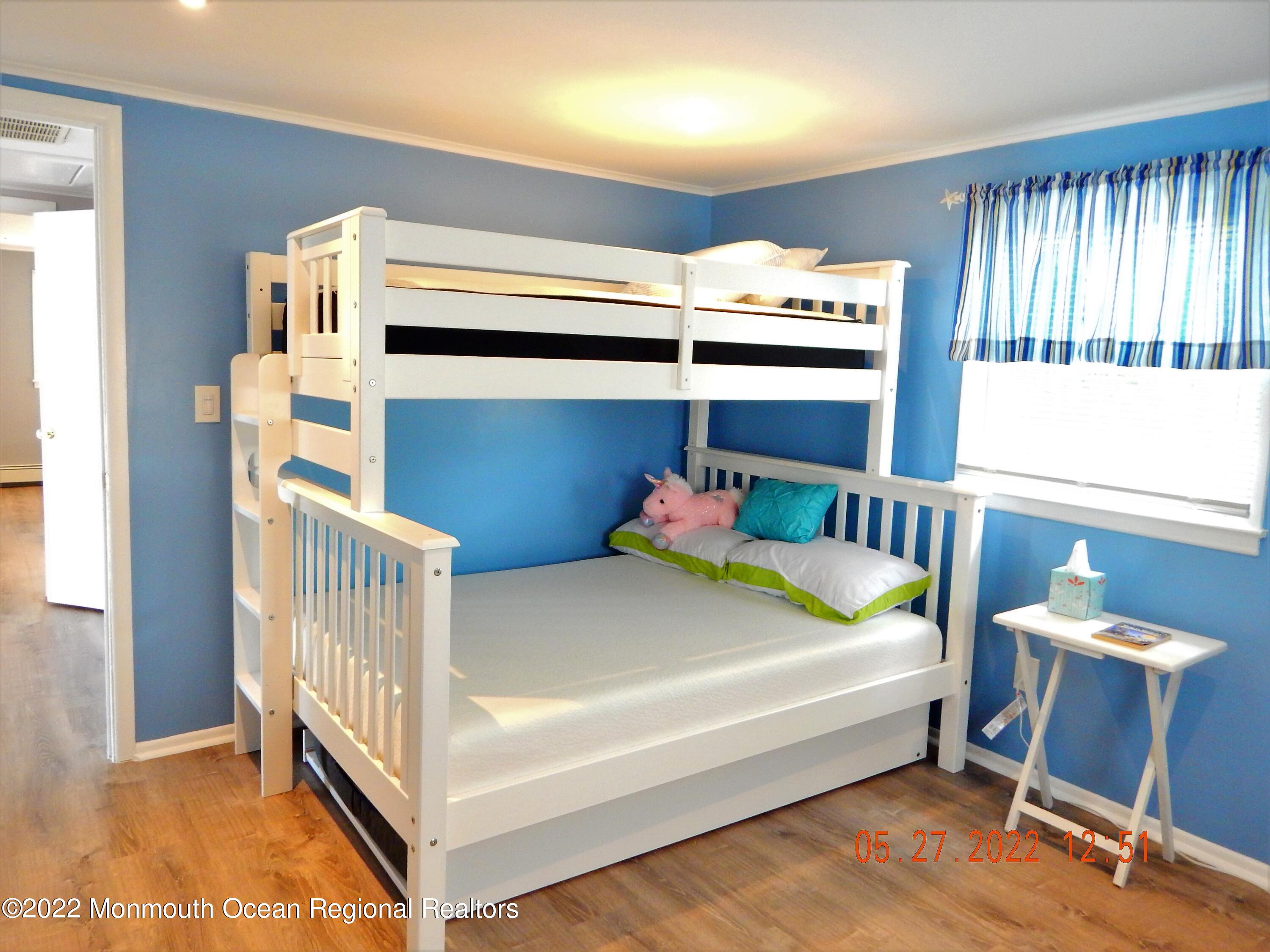 27 Club House Road Brick, NJ 08723 - Photo 18 of 31 a bedroom with a bed and a chair