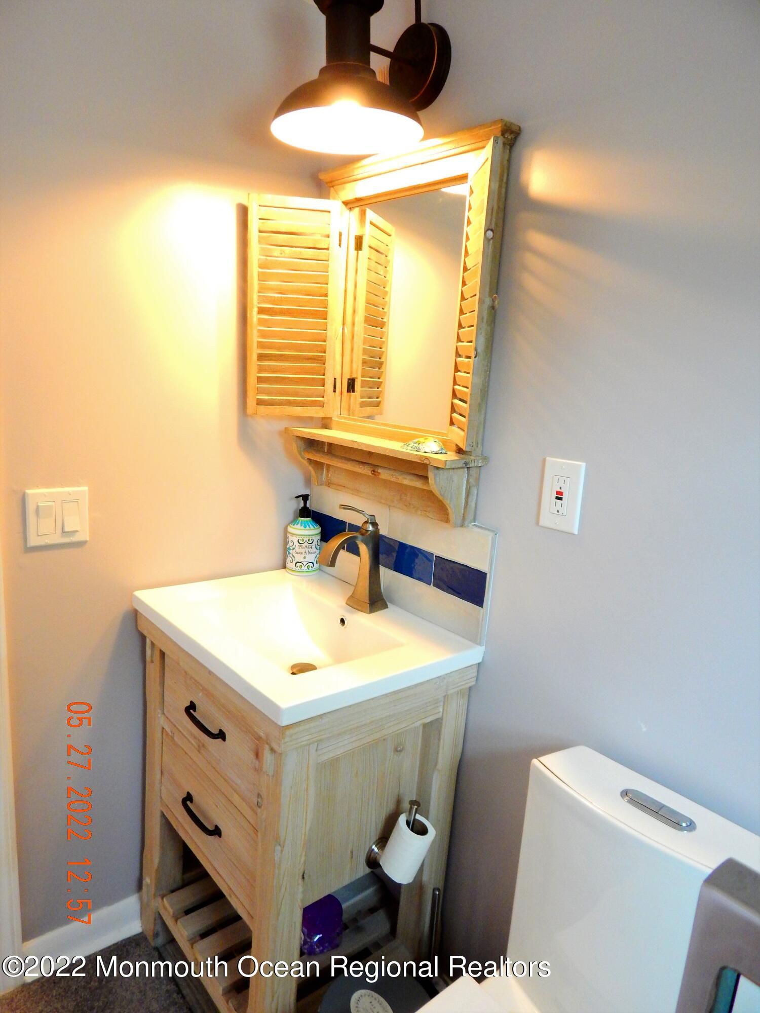 27 Club House Road Brick, NJ 08723 - Photo 21 of 31 a bathroom with a sink and a mirror