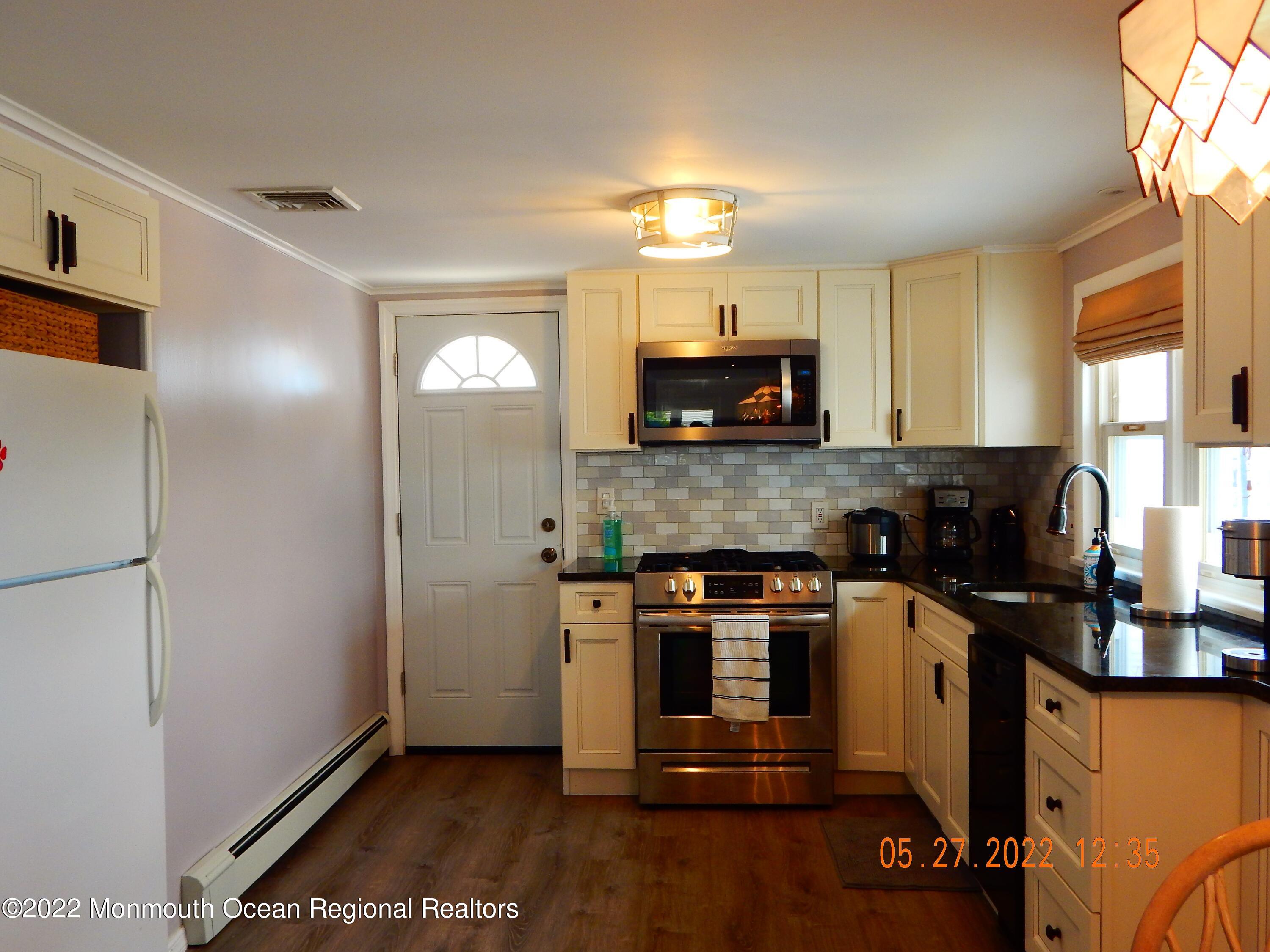 27 Club House Road Brick, NJ 08723 - Photo 6 of 31 a view of a kitchen with a sink wooden floor and a window