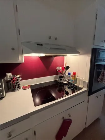 a kitchen with granite countertop a sink cabinets and window