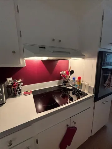 a kitchen with granite countertop a sink cabinets and window