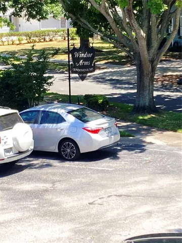 a view of yard with swimming pool and tall trees