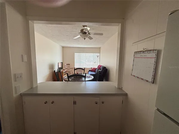 a kitchen with a white cabinets and window