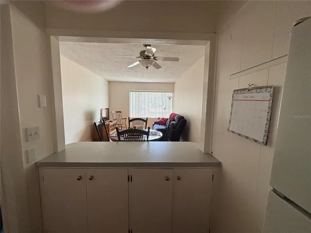 a kitchen with a white cabinets and window