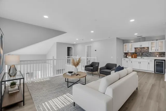 a living room with furniture and kitchen view