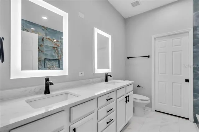 a bathroom with a sink double vanity and a window