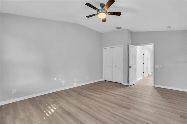 a view of an empty room and wooden floor