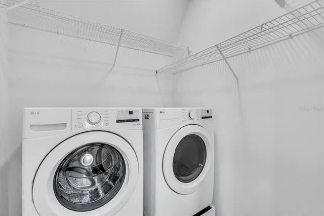 a view of a hallway with washer and dryer
