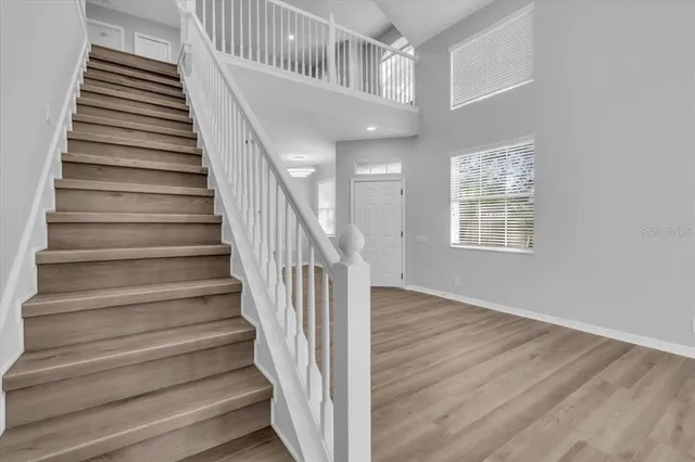 a view of entryway and hall with wooden floor