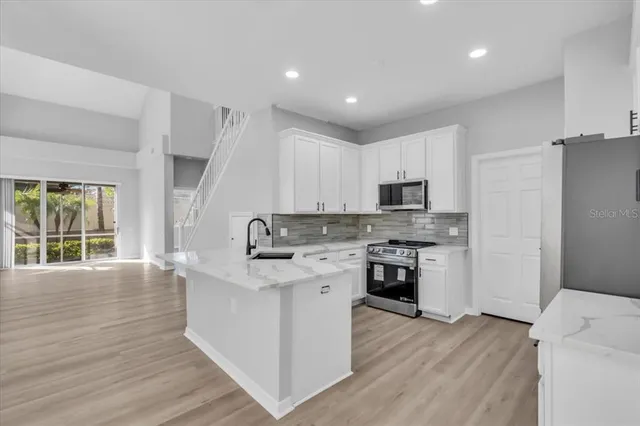 a kitchen with a stove a sink and a refrigerator