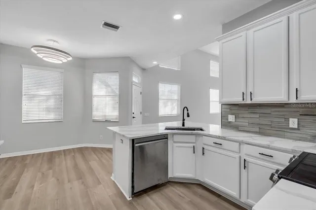 a kitchen with a sink stove and cabinets