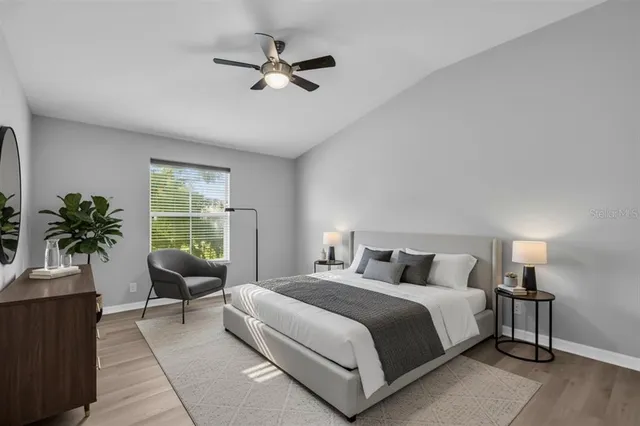 a bedroom with a large bed and a window