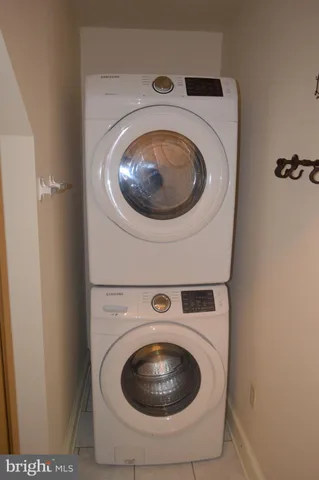 a view of a big room with wooden floor and windows