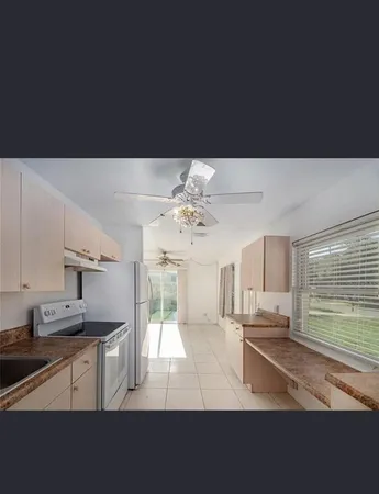 a kitchen with cabinets and window