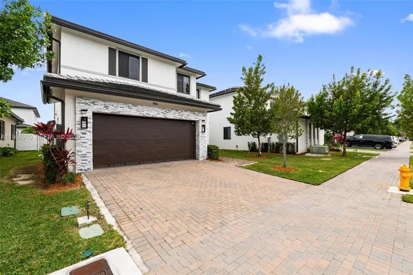 a front view of a house with a yard and garage