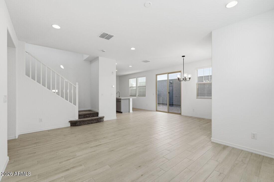 10048 West Piccadilly Road Avondale, AZ 85392 - Photo 11 of 49 a view of empty room with wooden floor
