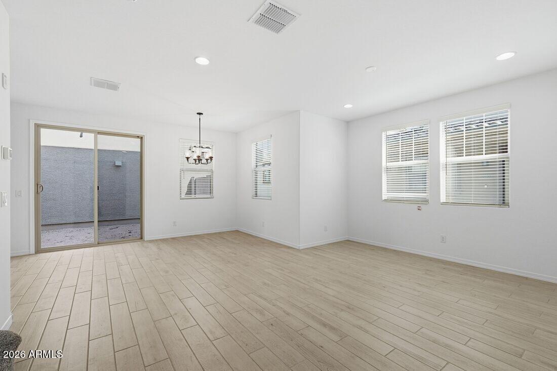 10048 West Piccadilly Road Avondale, AZ 85392 - Photo 12 of 49 wooden floor in an empty room with a window