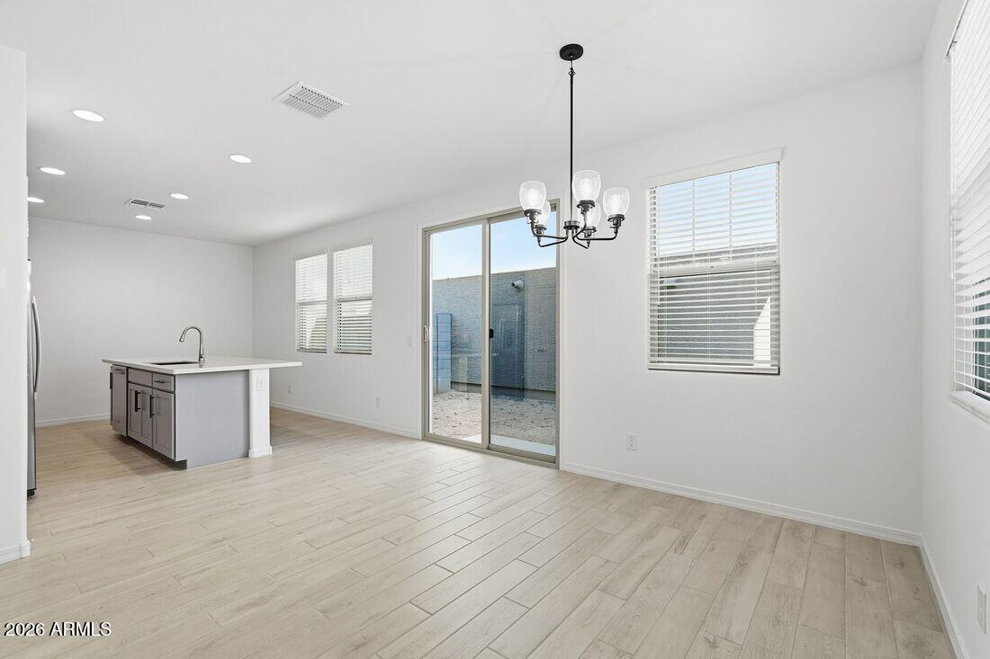 10048 West Piccadilly Road Avondale, AZ 85392 - Photo 14 of 49 a view of a livingroom with a furniture wooden floor and a window
