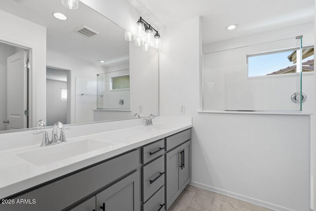 10048 West Piccadilly Road Avondale, AZ 85392 - Photo 19 of 49 a bathroom with a sink and a mirror