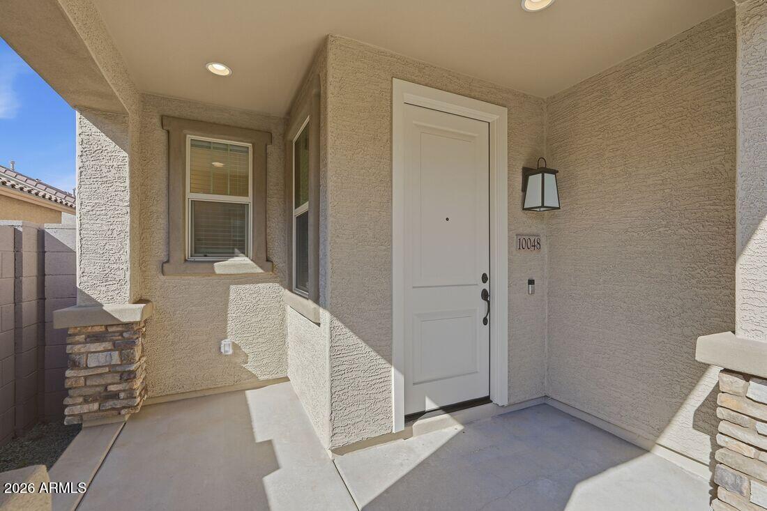 10048 West Piccadilly Road Avondale, AZ 85392 - Photo 2 of 49 a view of an entryway with wooden floor and a livingroom view